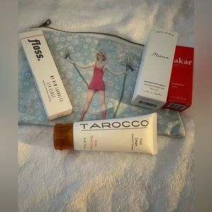 Cute cosmetic bag w/skin and lip products.   Brand new